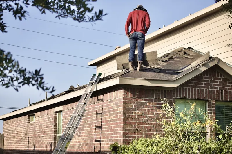 Professional roofer working on a residential roof in Trinity